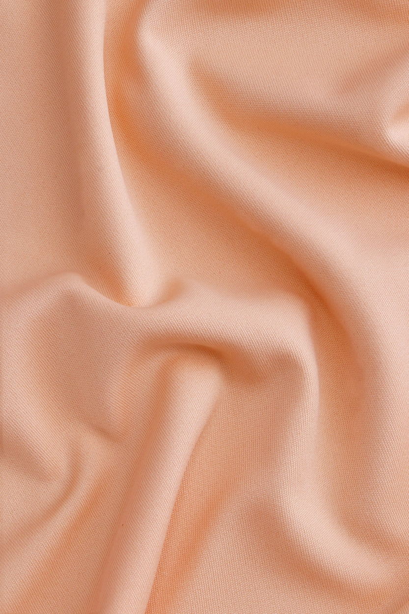 Osaka women tee short sleeve in peach with logo in grey. Detail fabric view