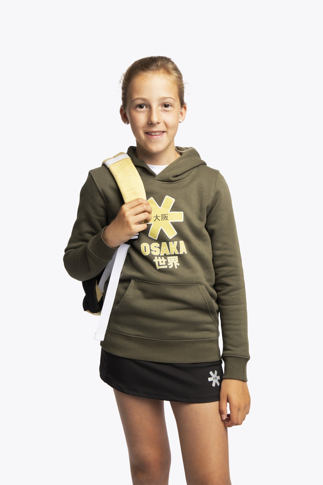 Osaka pro tour backpack in faded yellow with logo in white. Girl wearing the bag front view