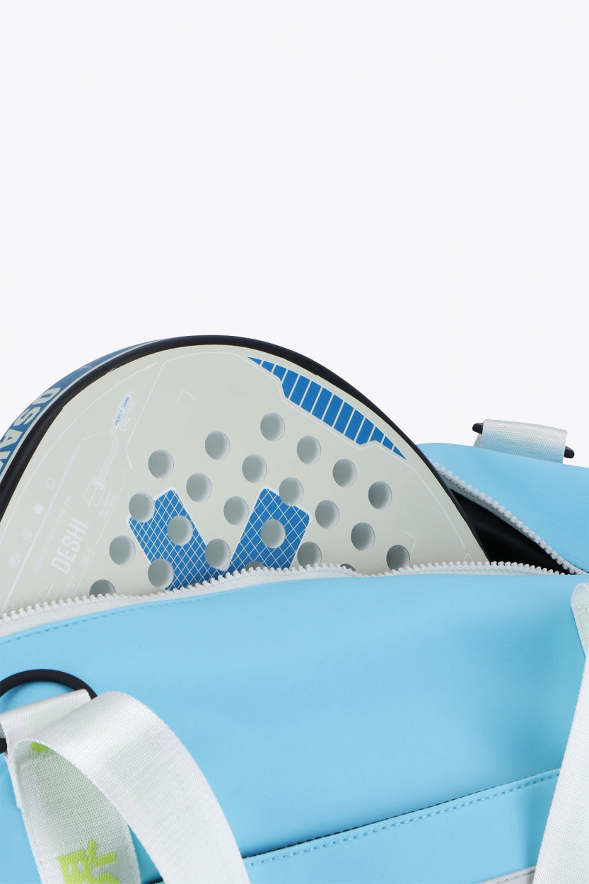 Osaka neoprene duffel bag in light blue with logo in white on the bag and in green on the straps. Detail view