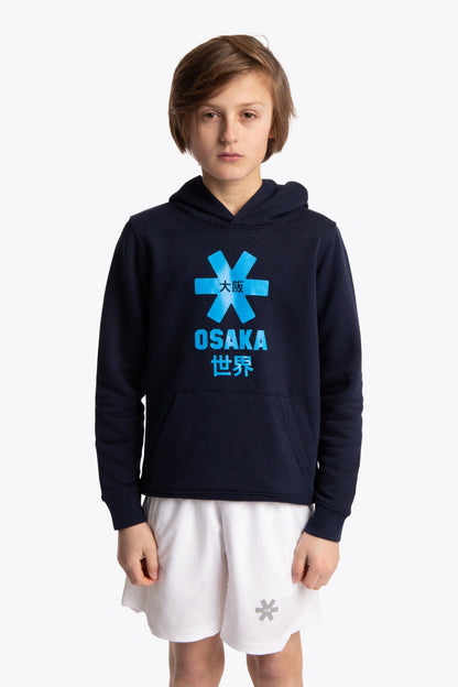 Boy wearing the Osaka kids hoodie in navy with blue star logo. Front view