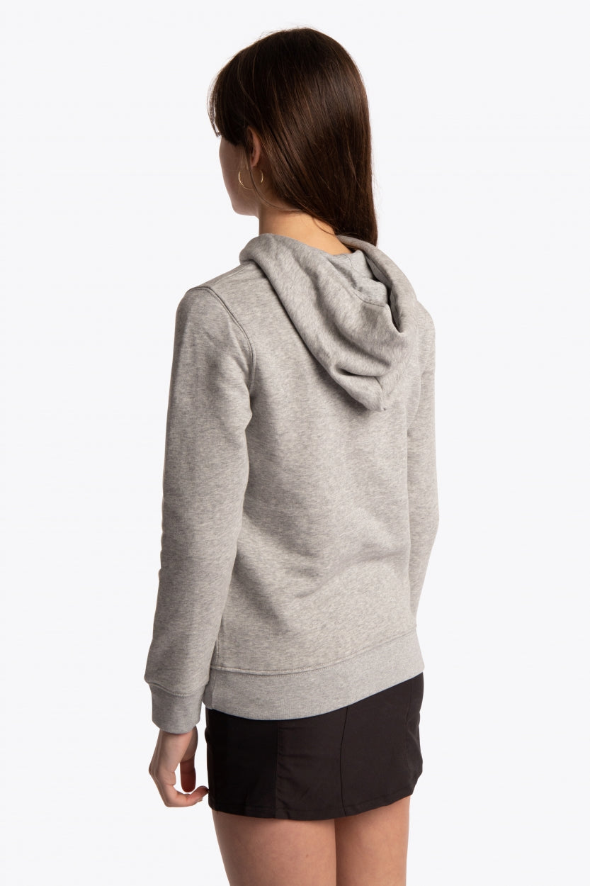 Girl wearing the Osaka kids hoodie in grey with blue star logo. Side/back view