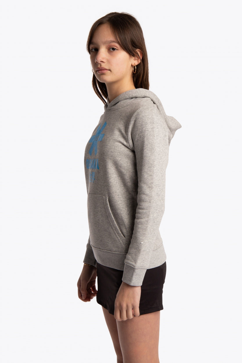 Girl wearing the Osaka kids hoodie in grey with blue star logo. Side view