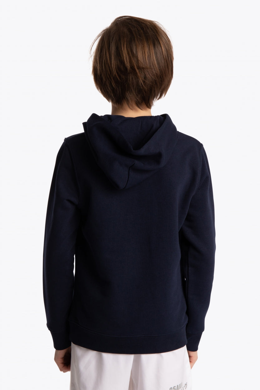 Boy wearing the Osaka kids hoodie in navy with green star logo. Back view