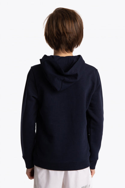 Boy wearing the Osaka kids hoodie in navy with green star logo. Back view
