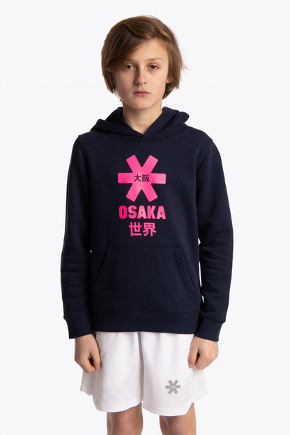 Boy wearing the Osaka kids hoodie in navy with pink star logo. Front view