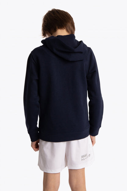 Boy wearing the Osaka kids hoodie in navy with pink star logo. Back view