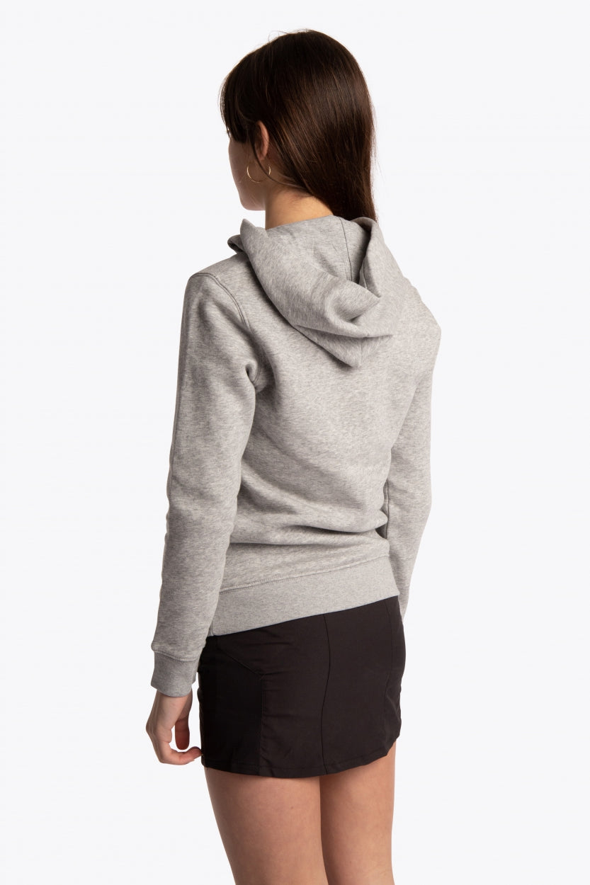 Girl wearing the Osaka kids hoodie in grey with pink star logo. Back/side view