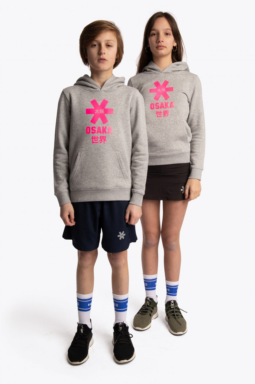 Boy and girl wearing the Osaka kids hoodie in grey with pink star logo. Front full view