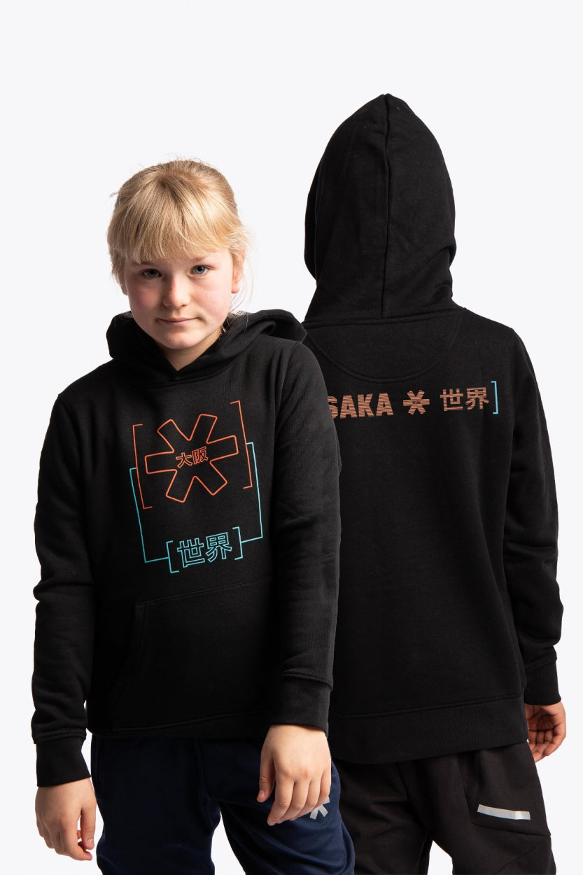 Girl wearing the Osaka kids trace hoodie in black with logo in orange and blue. Front and back view
