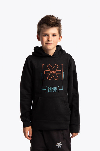 Boy wearing the Osaka kids trace hoodie in black with logo in orange and blue. Front view