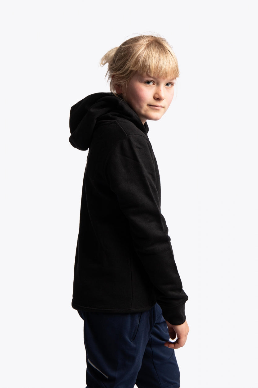 Girl wearing the Osaka kids hoodie in black with logo in orange and blue. Side view