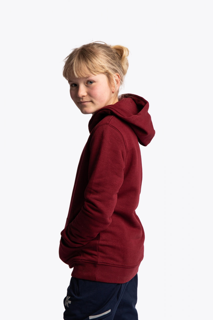 Girl wearing the Osaka kids vintage hoodie in burgundy with logo in orange. Side view