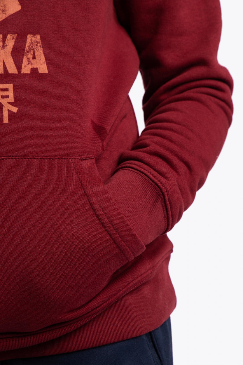 Osaka kids vintage hoodie in burgundy with logo in orange. Detail view sleeve and pocket