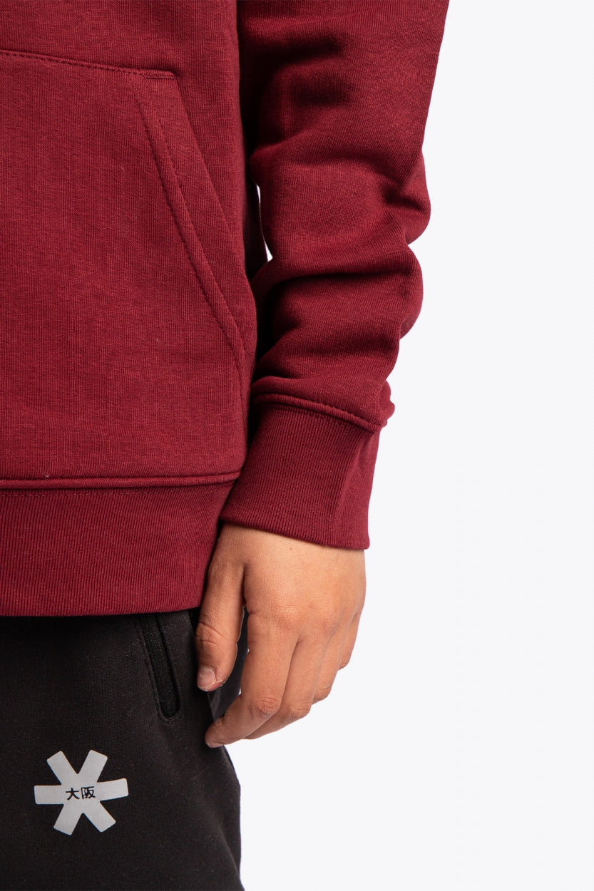 Osaka kids vintage hoodie in burgundy with logo in orange. Detail view sleeve