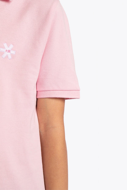 Osaka kids polo in cotton pink with logo in white. Detail view shoulder