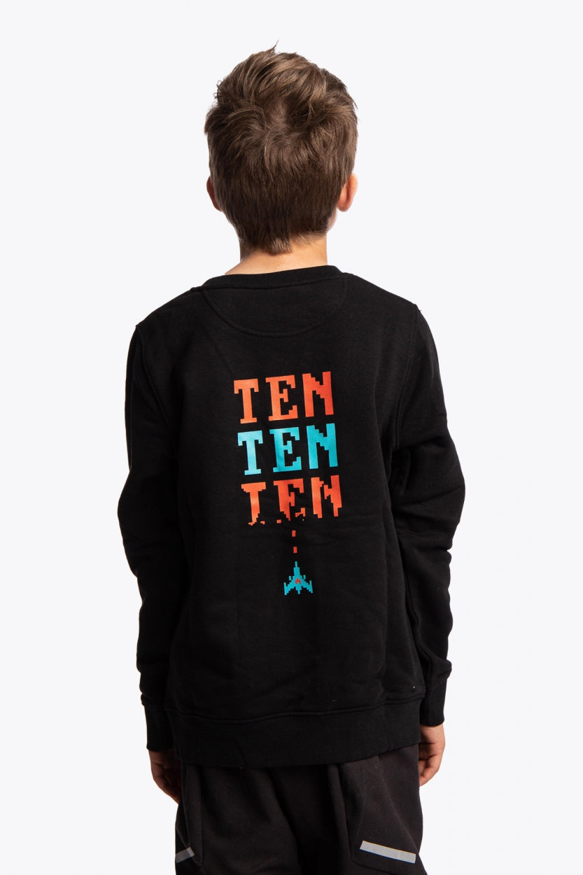 Boy wearing the Osaka kids pixo sweater in black with orange and blue logo. Back view