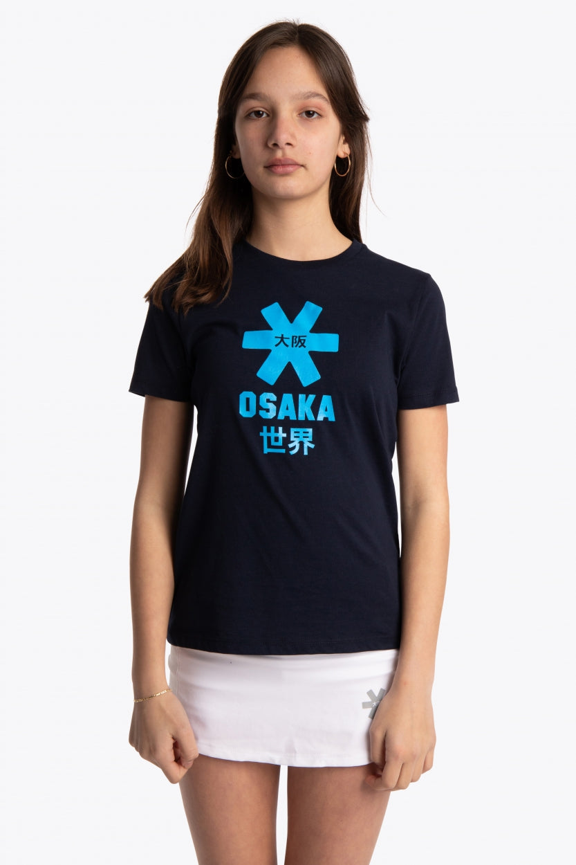 Girl wearing the Osaka kids tee short sleeve navy with logo in blue. Front view
