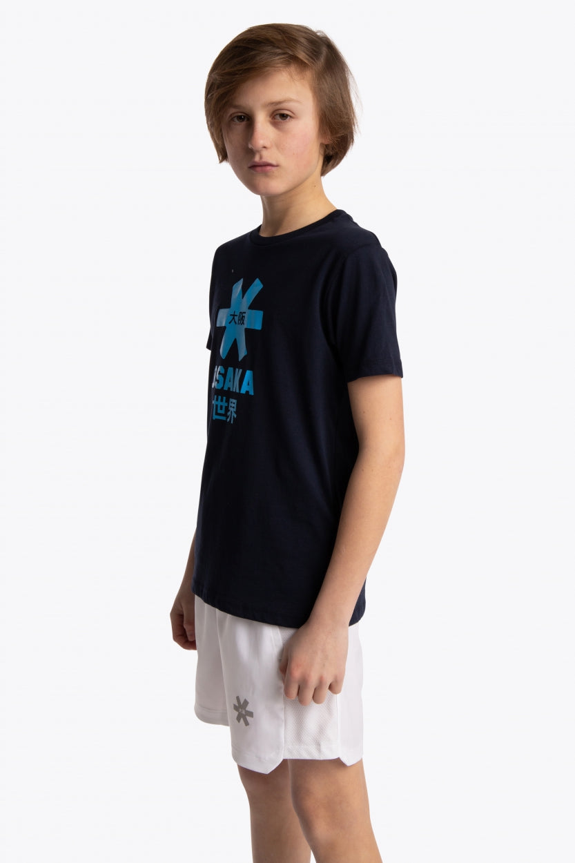 Boy wearing the Osaka kids tee short sleeve navy with logo in blue. Front/side view