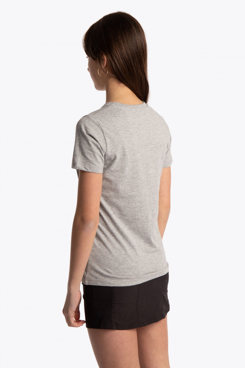 Girl wearing the Osaka kids tee short sleeve grey with logo in blue. Side/back view