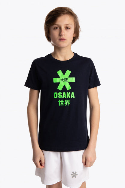 Boy wearing the Osaka kids tee short sleeve navy with logo in green. Front view
