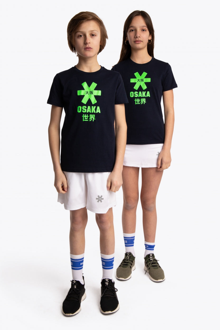 Boy and girl wearing the Osaka kids tee short sleeve navy with logo in green. Front full view
