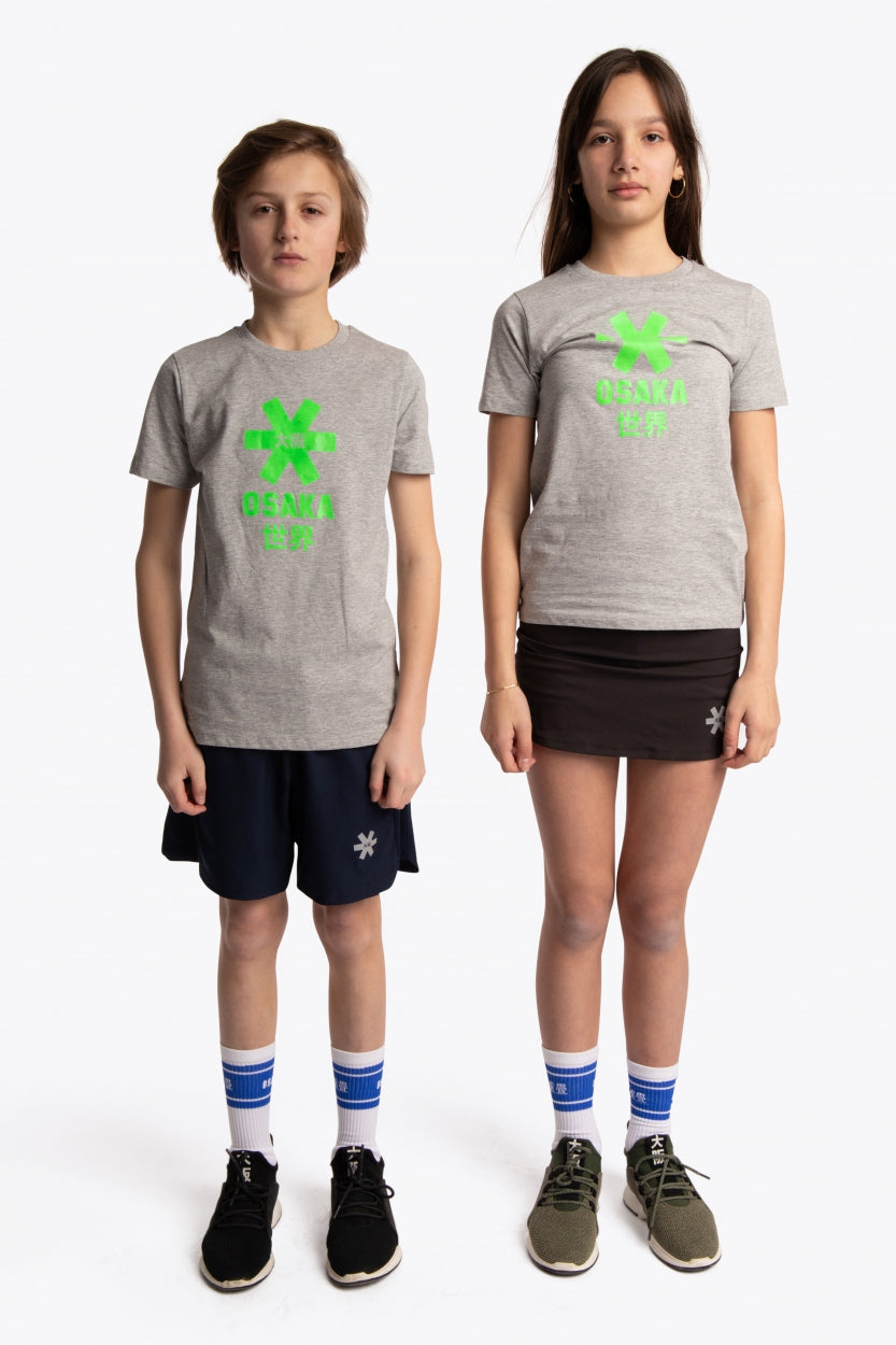 Boy and girl wearing the Osaka kids tee short sleeve grey with logo in green. Front full view