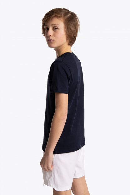 Boy wearing the Osaka kids tee short sleeve navy with logo in pink. Side view