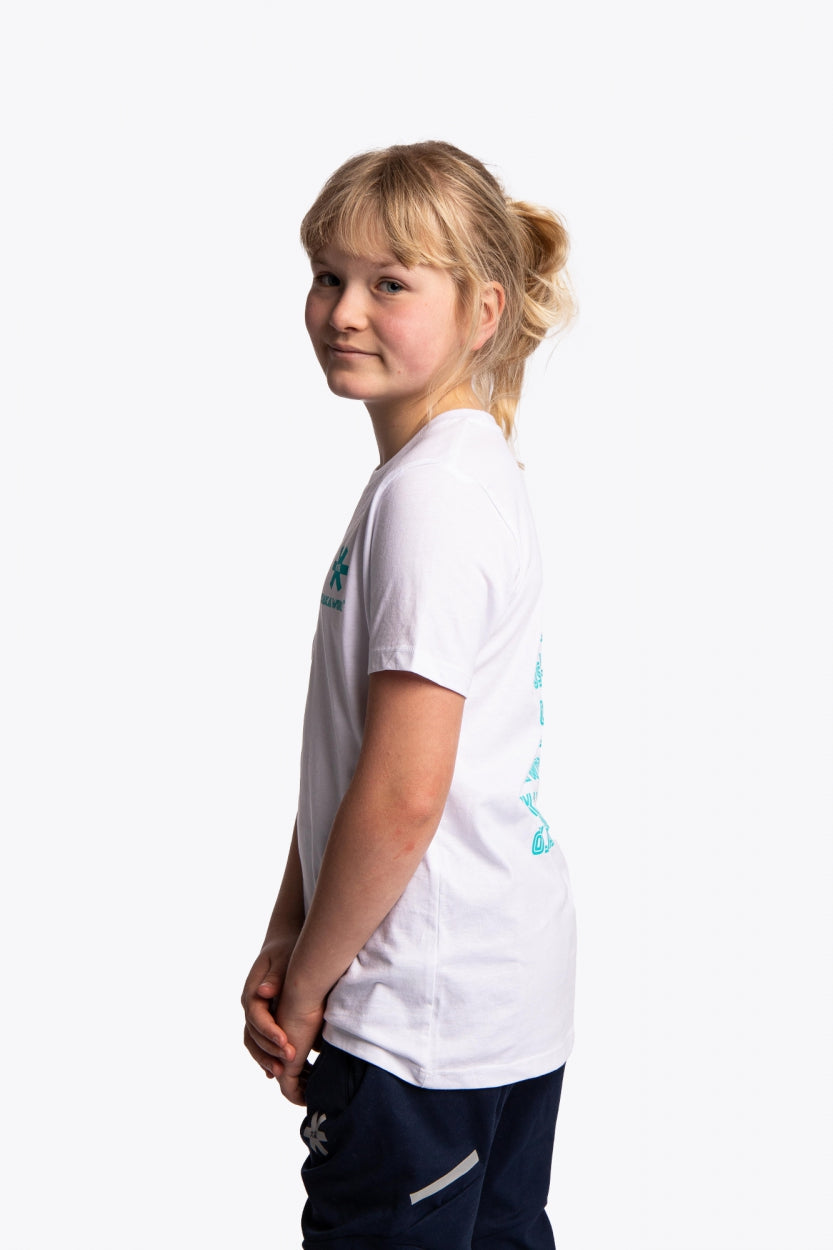Girl wearing the Osaka kids service games tee short sleeve white with logo in blue. Side view