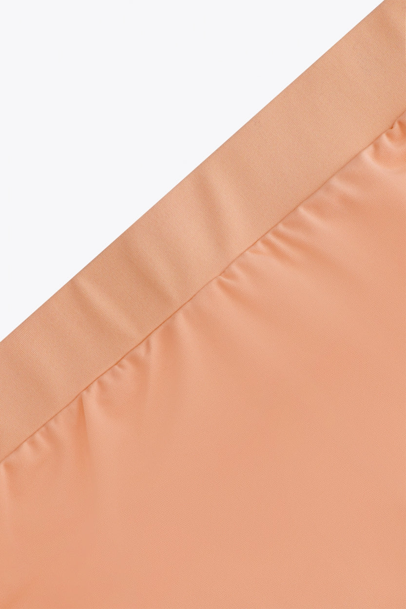Osaka women ball skort in peach with logo in grey. Detail view