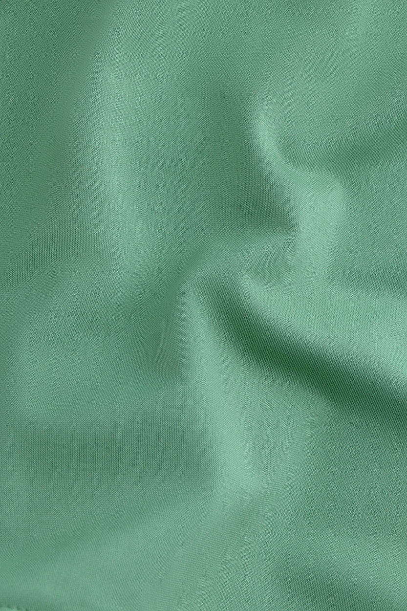 Osaka women ball skort in green with logo in grey. Detail fabric view