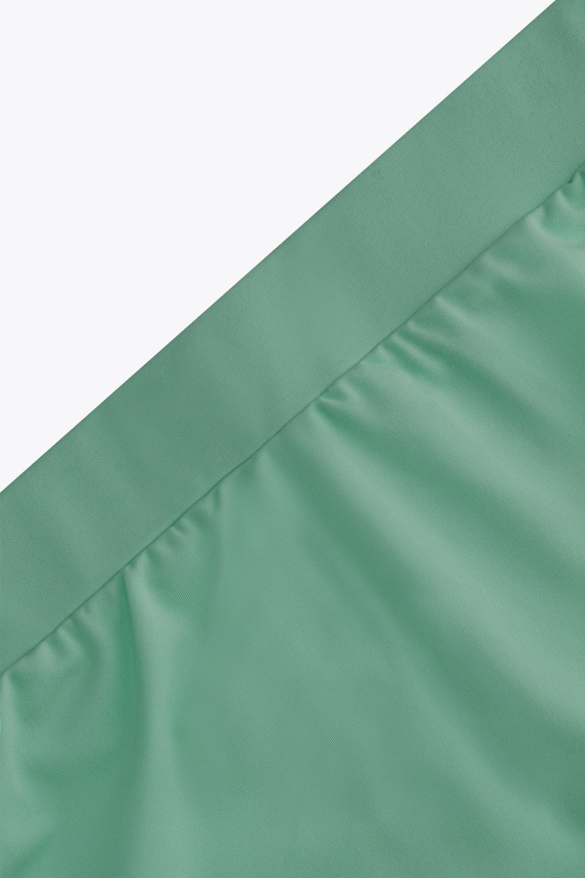 Osaka women ball skort in green with logo in grey. Detail view