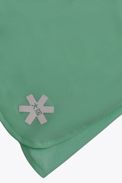 Osaka women ball skort in green with logo in grey. Detail logo view