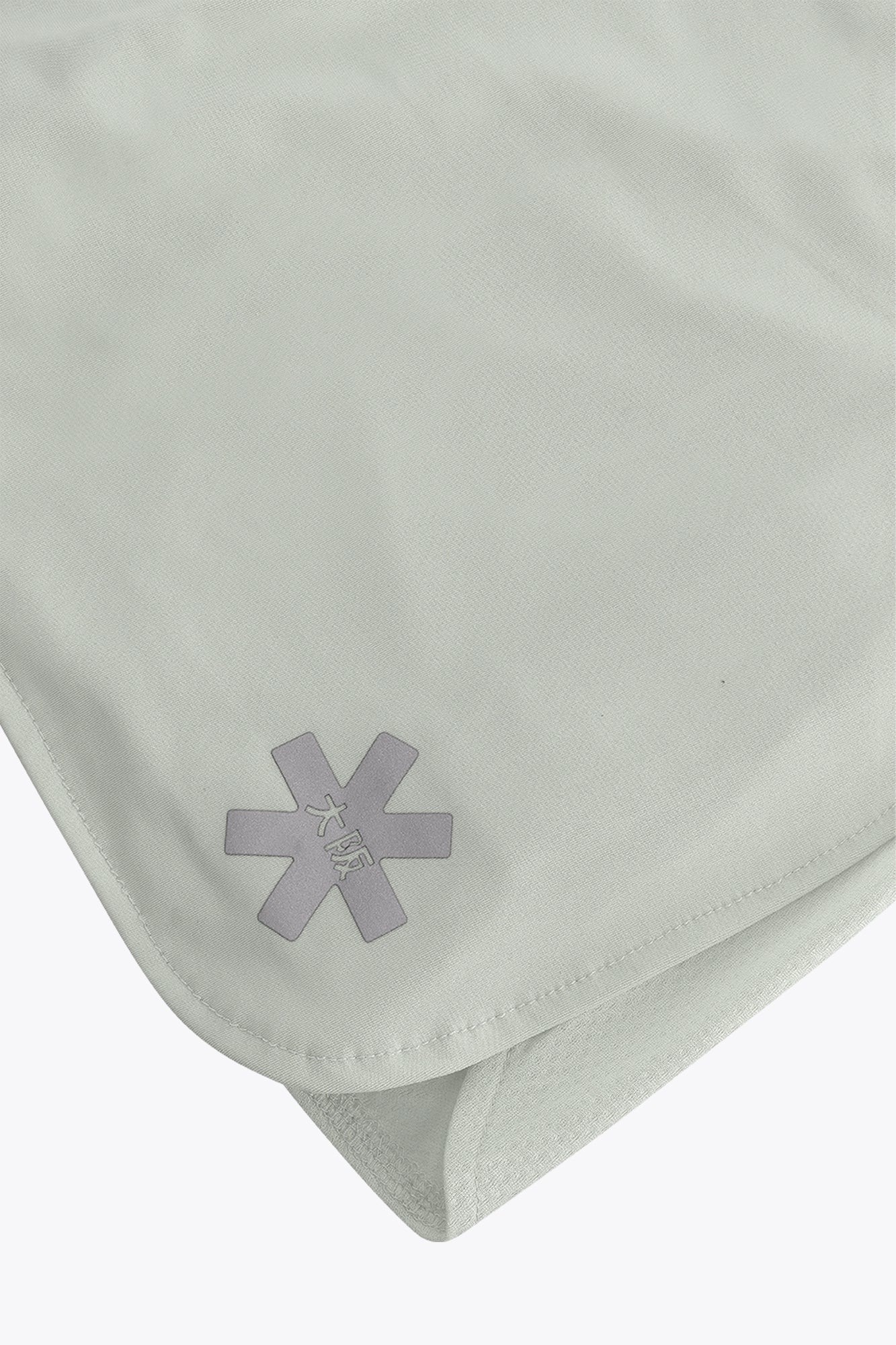 Osaka women ball skort in light grey with logo in grey. Detail logo view