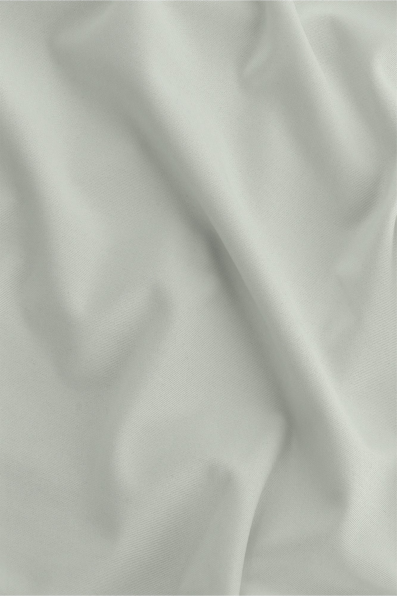 Osaka women ball skort in light grey with logo in grey. Detail fabric view