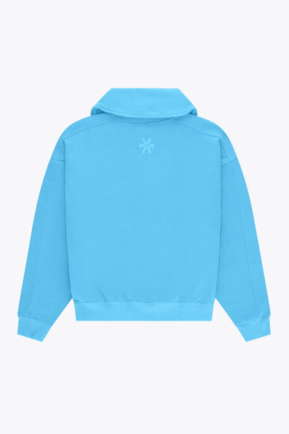 Osaka women half zip sweater in light blue with white logo. Back flatlay view
