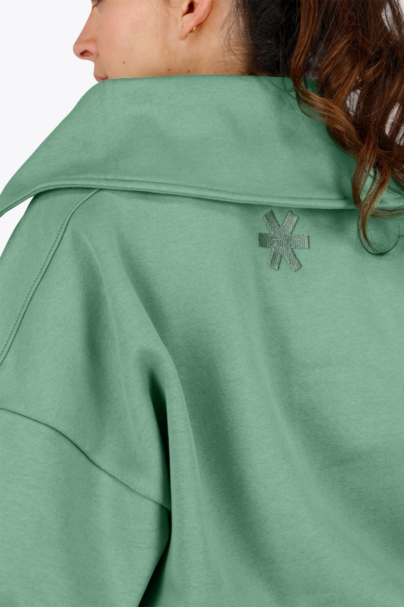 Woman wearing the Osaka women half zip sweater green. Back detail neck view
