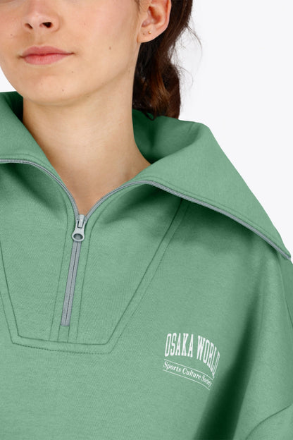 Woman wearing the Osaka women half zip sweater green. Front detail neck view