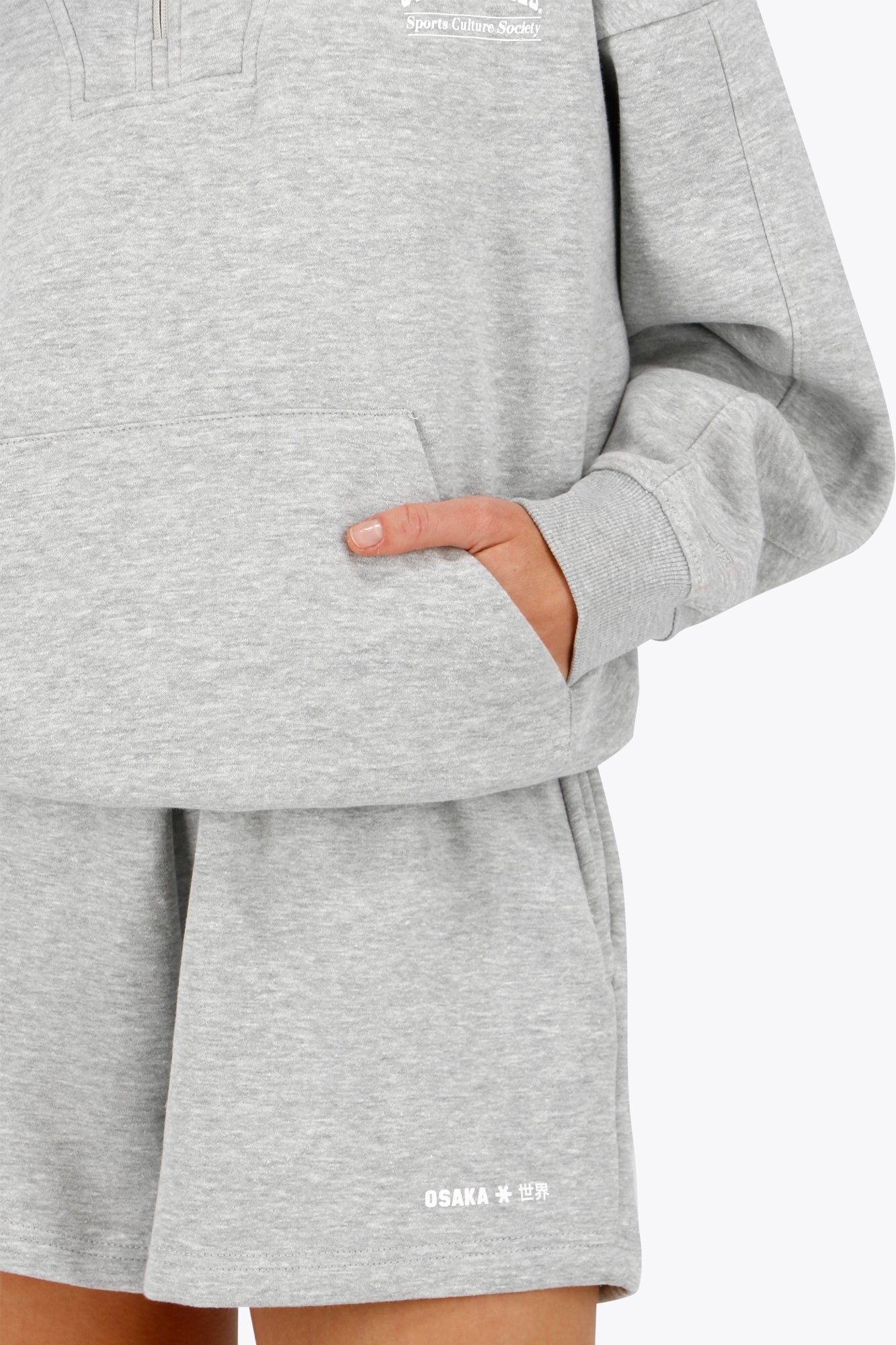 Osaka women half zip sweater in heather grey with white logo. Front detail sleeve view