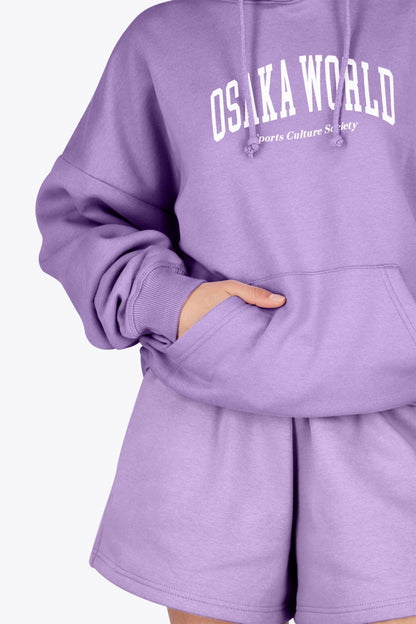 Woman wearing the Osaka women hoodie in light purple with white logo. Front detail sleeve view