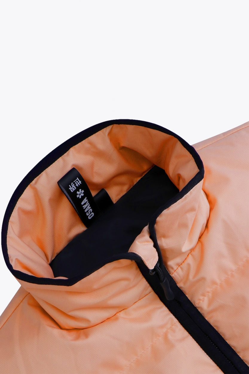 Osaka women padded gilet in peach with grey logo. Front flatlay detail neck view