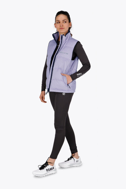 Woman wearing the Osaka women padded gilet in purple with grey logo. Front view
