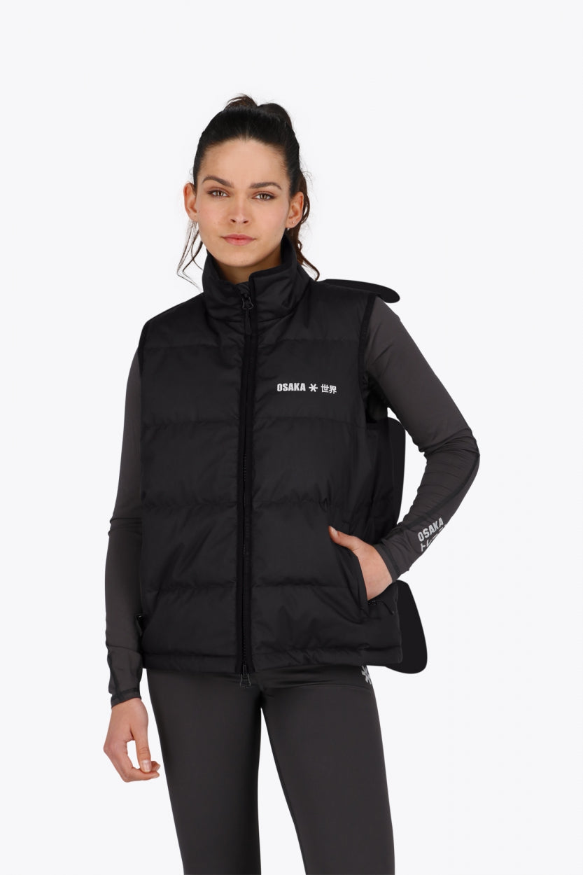 Woman wearing the Osaka women padded gilet in black with white logo. Front view