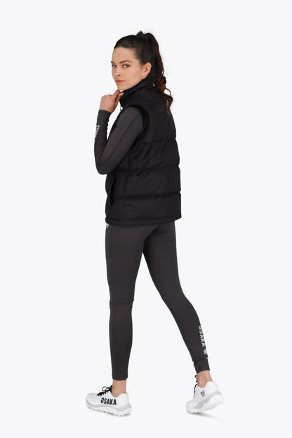 Woman wearing the Osaka women padded gilet in black with white logo. Back view
