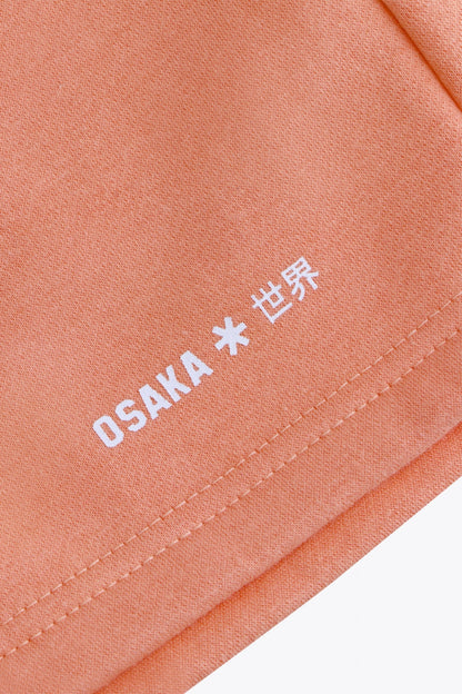 Osaka women shorts in peach with logo in white. Front flatlay detail logo view