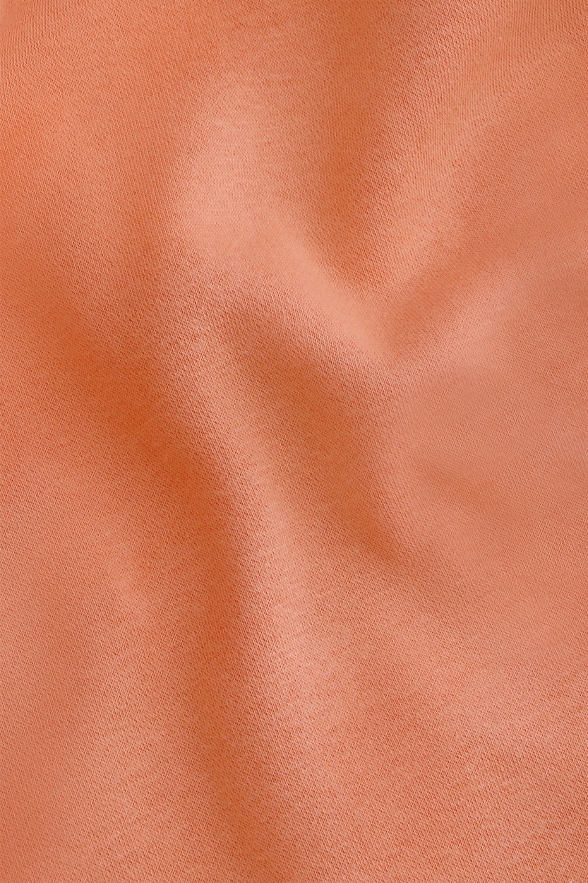 Osaka women shorts in peach with logo in white. Front detail fabric view