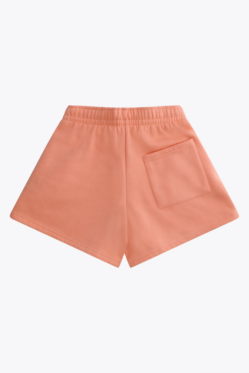 Osaka women shorts in peach with logo in white. Back flatlay view