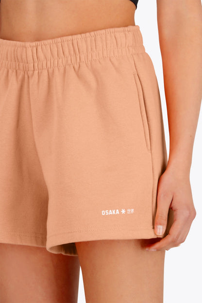 Osaka women shorts in peach with logo in white. Front detail logo view
