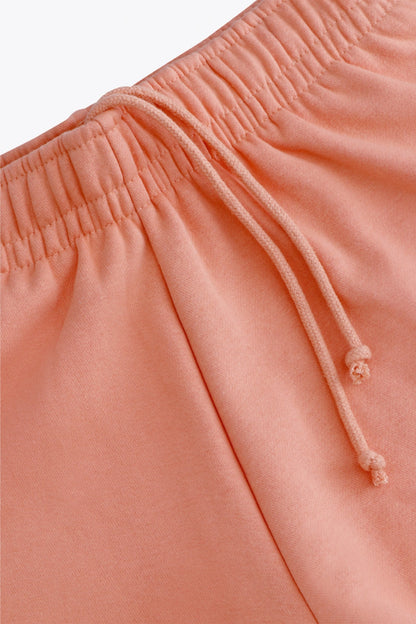 Osaka women shorts in peach with logo in white. Front flatlay detail cords view