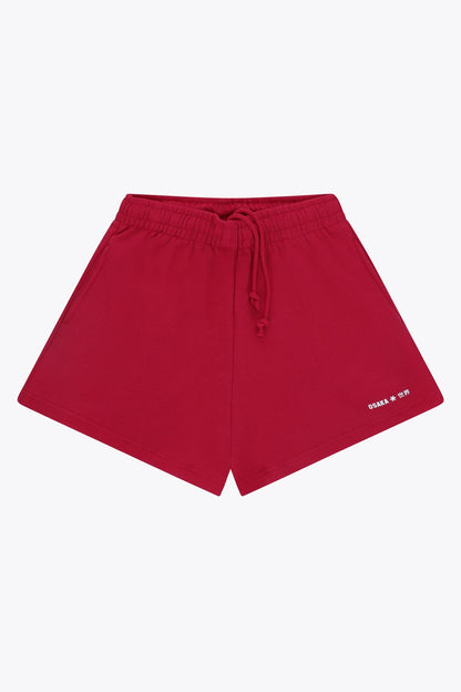 Osaka women shorts in red with logo in white. Front flatlay view