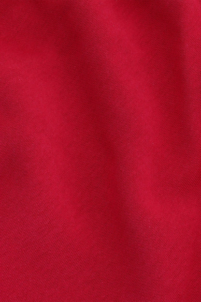 Osaka women shorts in red with logo in white. Front detail fabric view